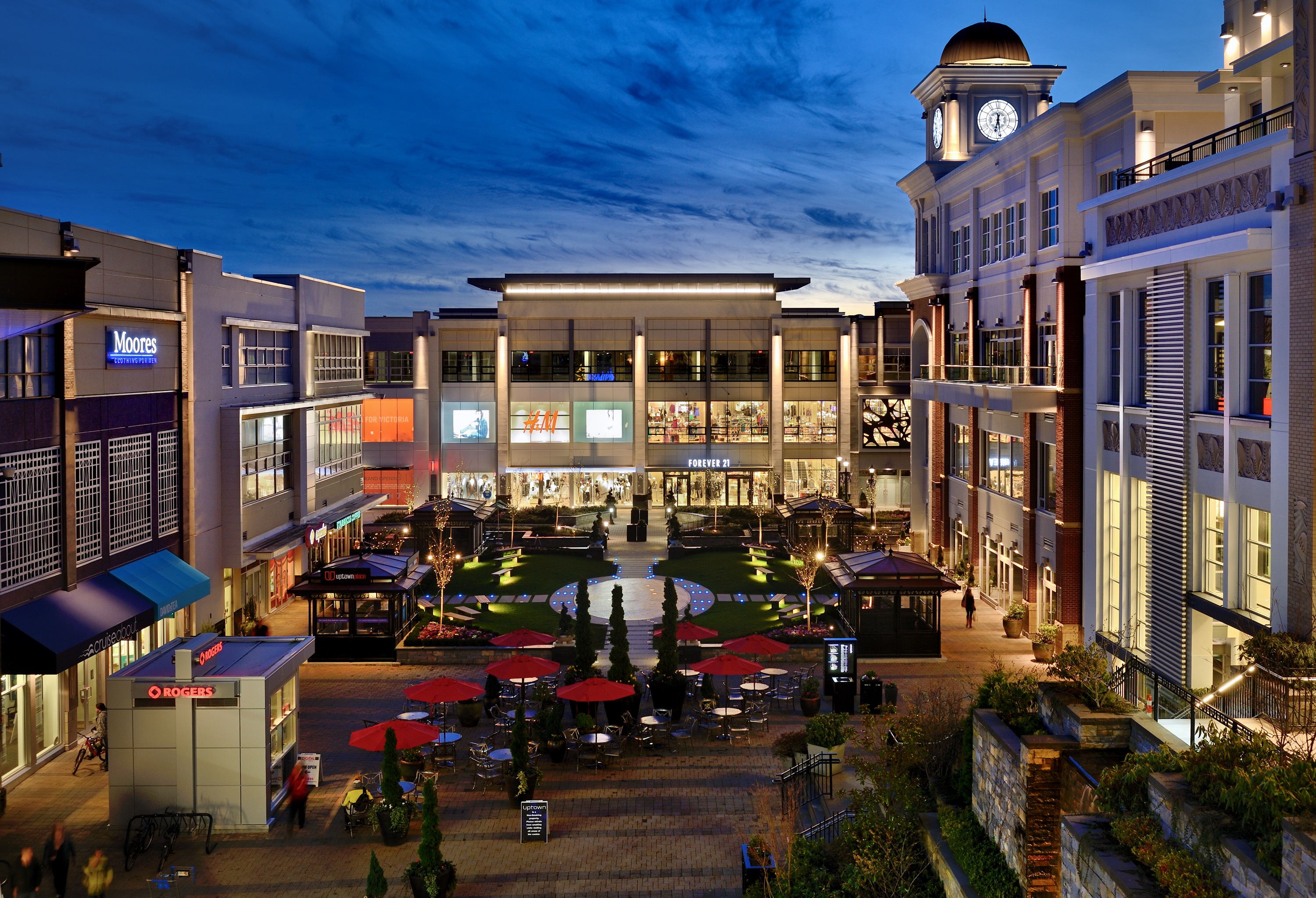 Evening view of a mixed-use retail village with illuminated architecture